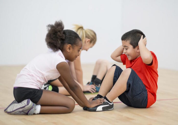 Kids gym class and excercise in gymnasium