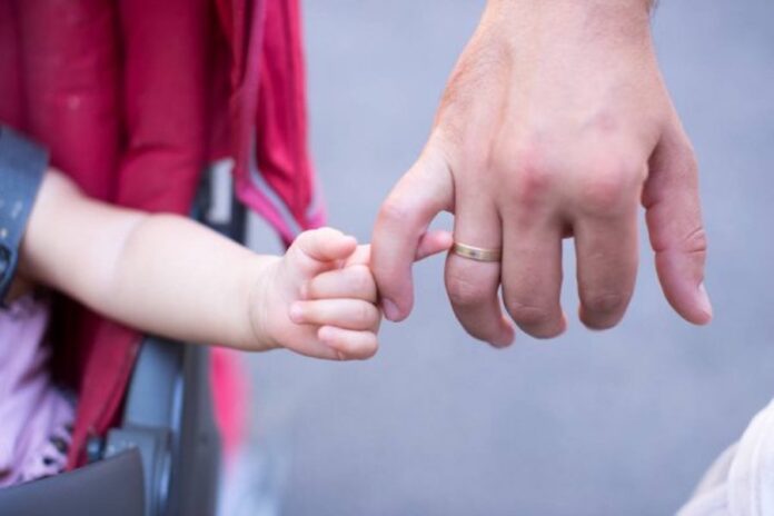 depositphotos_146860027-stock-photo-close-up-of-father-holding