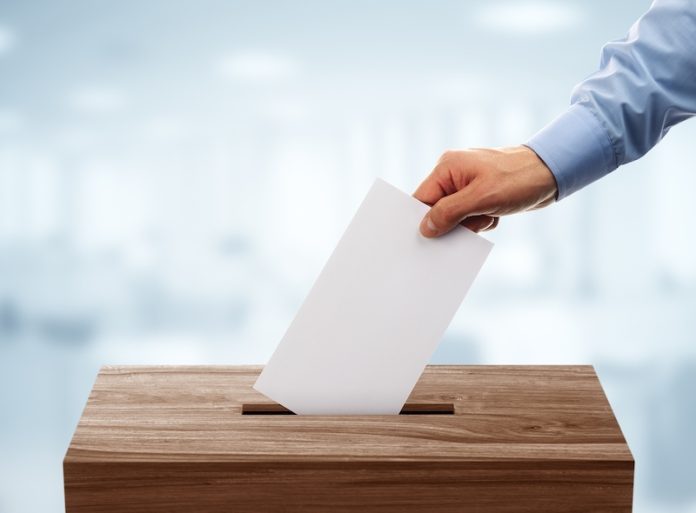 bigstock-ballot-box-with-person-casting-107447402-e1518101056311