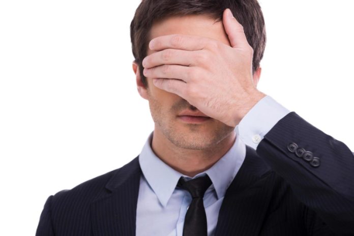 i-saw-nothing-portrait-of-young-man-in-formalwear-covering-eyes-with-hand-while-standing-isolated-on-white-background-free-photo