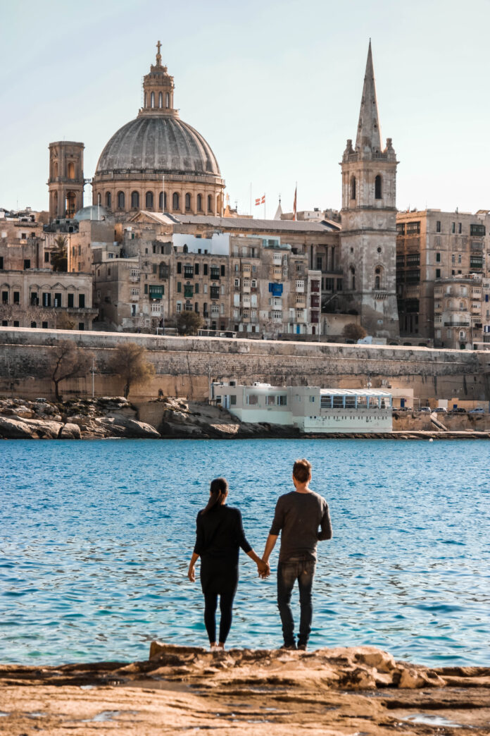 Valletta Malta city Skyline, colorful house balcony Malta Valletta , young couple on vacation in Malta
