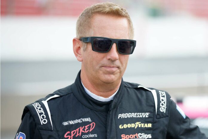 Greg-Biffle-69-stands-on-the-grid-during-practice-121825-a9ee4b9482ca45bd907fdd343d0d3243