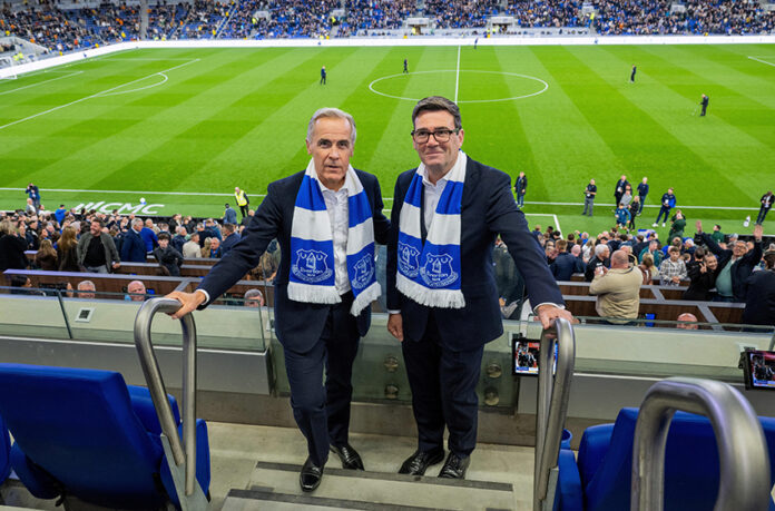 Canadian PM Mark Carney and British PM Andy Burnham watch Everton v Wolverhampton Wanderers in Liverpool