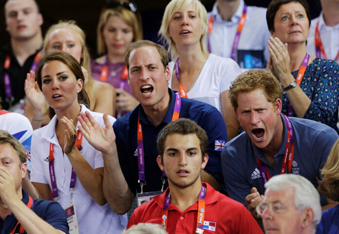 FILE PHOTO: Britain's Prince William, his wife Catherine, Duchess of Cambridge and Prince Harry cheer for the British team as they watch the track cycling event at the Velodrome during the London 2012 Olympic Games